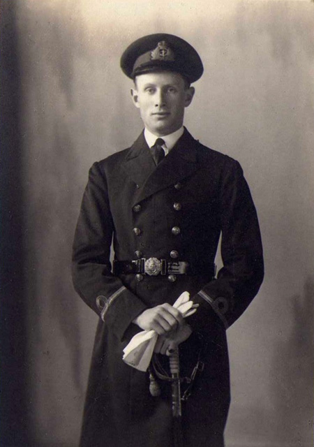 Studio portrait of Sub Lt C.G.W. Donald RN in dress uniform with sword