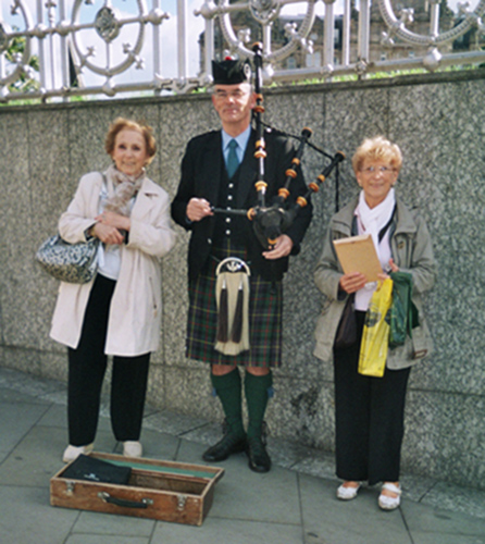 Posing with bagpipe player in Edinburgh
