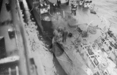 USS Hughes alongside Hecla while under repair, 1941